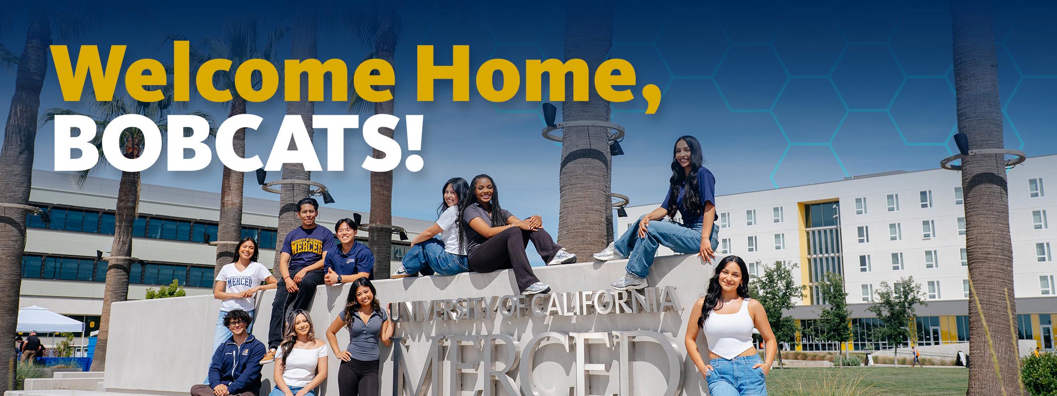 Become a uc merced bobcat UC Merced students posing for the camera next to uc merced signage