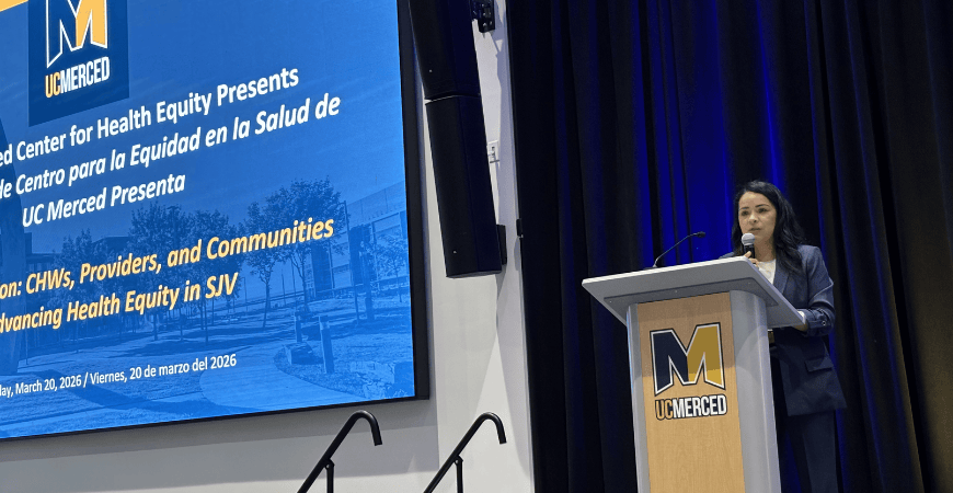 Dr. Rosa Manzo speaking from behind a podium