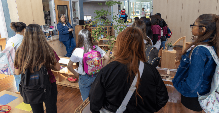 Early Childhood Education Center Director Danielle Waite speaks to a group of visiting students
