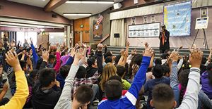 Students interact with The Sonnet Man at Gracey Elementary School in Merced.