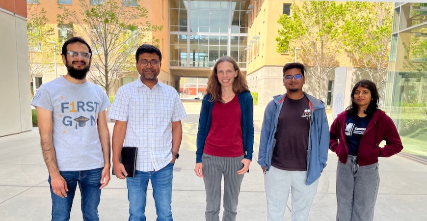 Photo depicts Elizabeth Nowadnick, center, surrounded by members of her lab on campus at UC Merced.