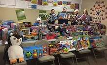 CASA representatives receive gifts donated by UC Merced campus members for children of Merced County. 