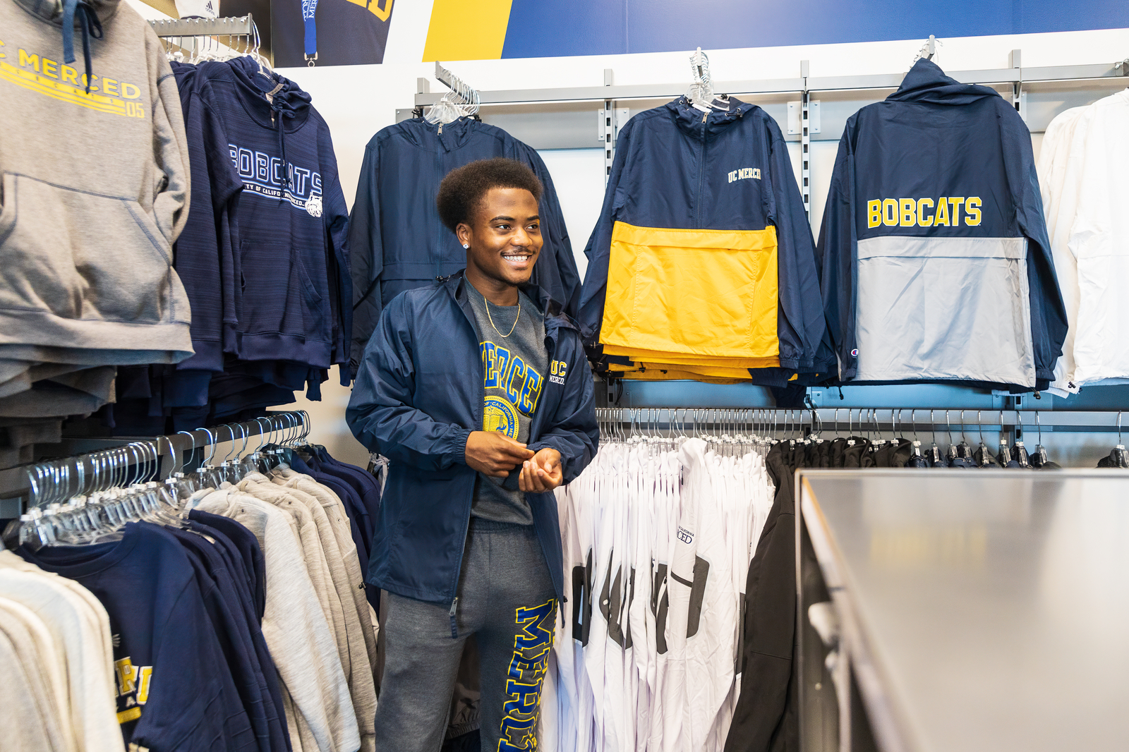 A cashier rings up a purchase at an on-campus retail store.