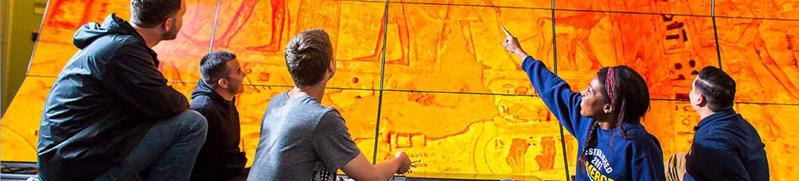 students looking at old architecture on multiple monitors