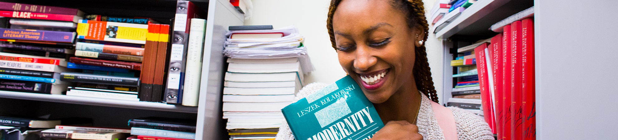 female student hugging a book about american law