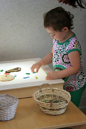 baby girl playing with toys on a table