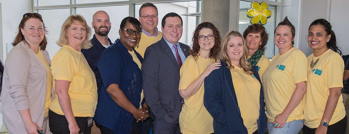 Ten staff members pose with UC Merced's AVC of Human Resources