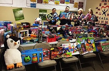 CASA representatives receive gifts donated by UC Merced campus members for children of Merced County. CASA representatives receive gifts donated by UC Merced campus members for children of Merced County.