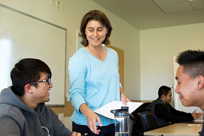 Professor Ashlie Martini works with some of her Design Thinking students.