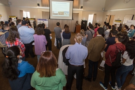 Attendees listen to a presentation during the MACES open house.