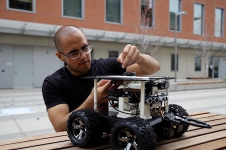 Manuel Meraz works with one of the 'Swarmies' in preparation for the Swarmathon competition.