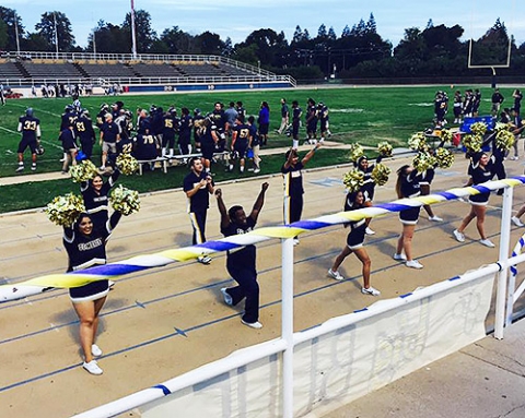 UC Merced’s Cheer Team roots for the Merced College Blue Devils’ football team.