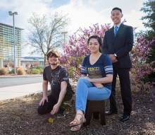 Alex Newman, left, Gabriel Morabe, standing, and Adriana Gomez are this semester's Carbon Neutrality Fellows.