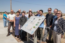 Some of the students who helped create the new interactive sign stand with Professor Martha Conklin, right, and others who attended the sign's unveiling.