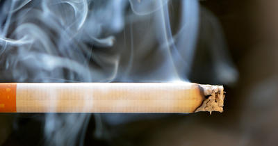 A lit cigarette is seen in an undated image.