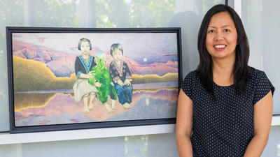 UC Merced Professor Ma Vang and print of painting that is on the cover of her book 