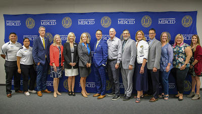 UC Merced Chancellor Juan Sánchez Muñoz, Modesto City Schools Superintendent Sara Noguchi and other educational leaders pose for a photo.