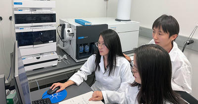 Students Zeyi Moo, back left, and Yaying Wang, right, work with Professor Xuan Zhang, center, on her Alzheimer's-related research. Photo courtesy of Kate Marsh.