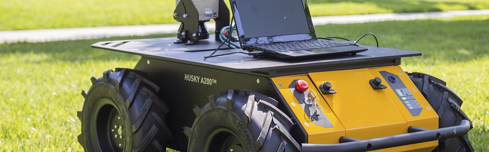 Robotic four-wheel vehicle with laptop mounted on top.